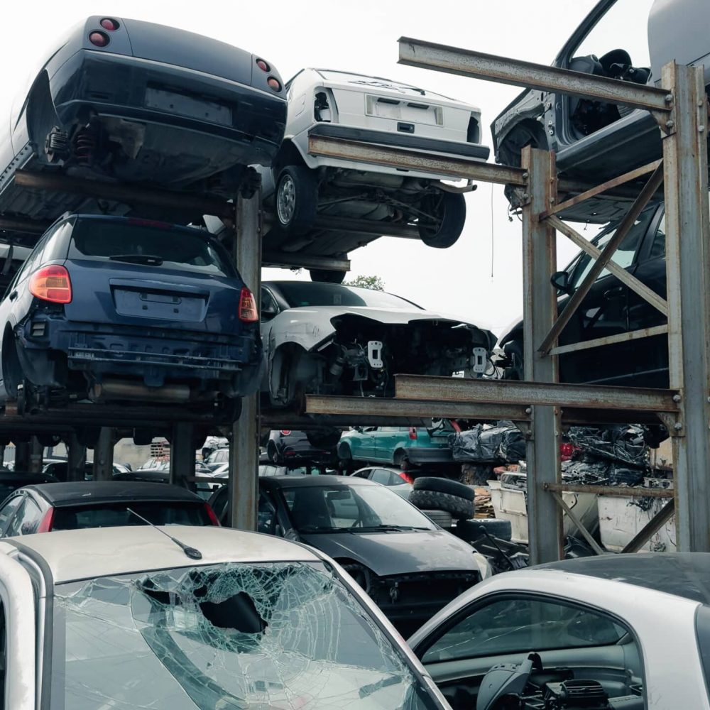 stacked scrap cars. recovery of car components.